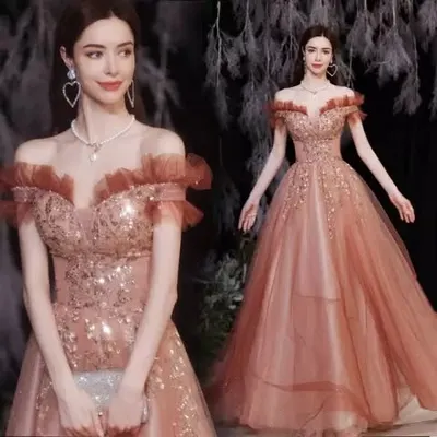 This rust-colored cocktail gown is designed to make a statement. With its off-shoulder neckline, ruffled details, and sparkling fabric, it's the perfect rental for a glamorous party or wedding reception.
