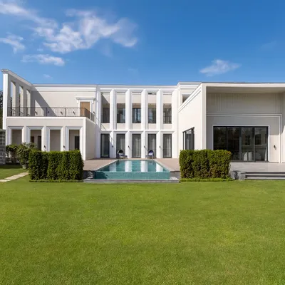 The facade of our Chhattarpur farmhouse project, showcasing clean lines, classical proportions, and an inviting connection between the home and the expansive landscape. We design for timelessness, creating exteriors that are as elegant today as they will be decades from now.