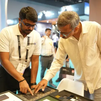 A visitor gets a hands-on demonstration of a smart switch panel, testing the tactile feel and responsiveness of the latest control interfaces.