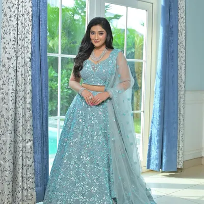 An ethereal ice blue lehenga covered in shimmering sequins. This rental is perfect for a winter wedding or a glamorous reception, giving you a unique, frozen-inspired look.