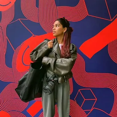 My camera is always with me. I find inspiration everywhere, especially in art and design. This photo, taken against a vibrant mural, reflects my own creative energy and the graphic, modern style I bring to my photography.
