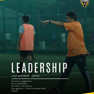 Leadership isn't loud, it's clear. A coach directing his players on the field, demonstrating the vision and control we teach. We don't just train players, we shape leaders.