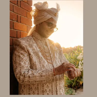 The golden hour for a golden groom. Sahas looks dapper in his intricately embroidered sherwani, the warm sunlight adding a magical glow to his wedding day portrait.