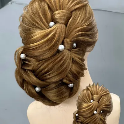 A clear, detailed look at an advanced bridal bun. We practice these styles on mannequins until you get the technique just right.