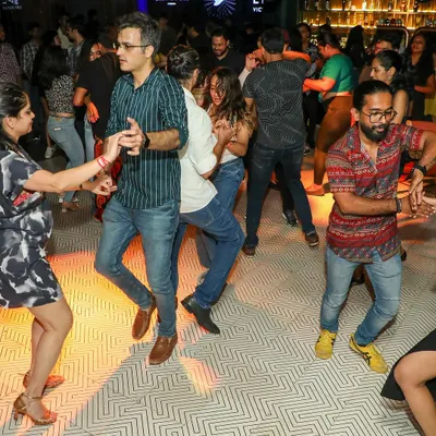 A packed floor at one of our Friday Night Open Floor events. This is where students from all our classes, from Salsa to Jive, come together to practice, socialize, and let loose after a long week.