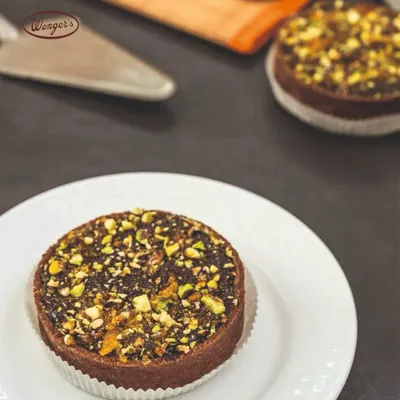 Our chocolate pistachio tart is a rich and nutty delight. The chocolate tart shell is filled with a decadent chocolate filling and generously topped with chopped pistachios.