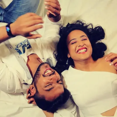 A pure, candid moment of a couple laughing together, captured from a unique overhead angle.