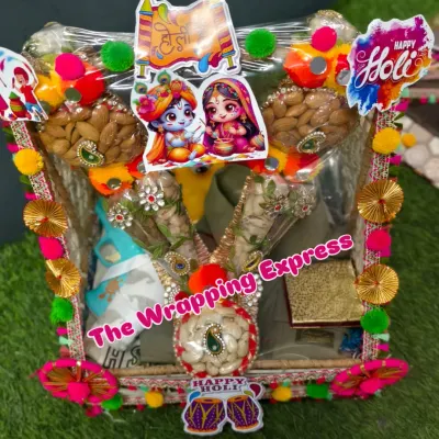 A vibrant Holi hamper decorated with Radha-Krishna stickers. This basket includes clothes, dry fruits in decorative cones, and other festive items.