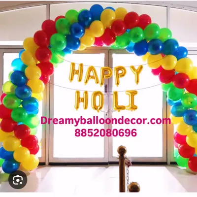Getting into the festive spirit with a colorful 'Happy Holi' decoration. This rainbow balloon arch is perfect for entryways at home or for office celebrations.