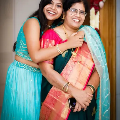 A candid moment of pure joy and laughter between a mother and daughter at a family event. We look for these authentic interactions that make the best memories.