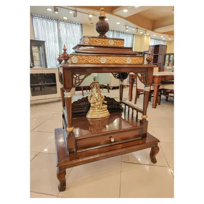 Another view of the solid teak wood pooja mandir, showing the rich grain of the wood and the detailed craftsmanship from a different angle. The design includes a drawer for storing pooja essentials.