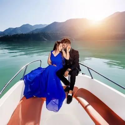 An intimate moment on a speedboat at Tehri Lake. The golden hour sunlight and the vibrant blue of the dress against the water create a truly magical and romantic pre-wedding photograph.