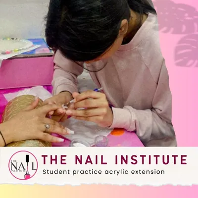 Practice makes perfect. A student carefully applies acrylic, building the structure for a durable and elegant nail extension.