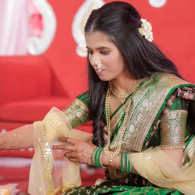 My engagement bride Karishma during her ceremony. The makeup is soft and traditional, complementing her green saree.
