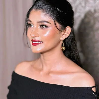 This is the epitome of modern glam. A sleek, wet-look hairstyle paired with luminous 'glass skin' and a classic red lip. This look is perfect for a cocktail party or a chic reception.