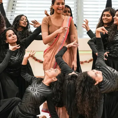 A joyful moment on stage, surrounded by my students during a performance. The connection between a teacher and students is truly special, and it shines during a showcase.