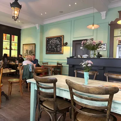 A postcard from Europe. Pausing at charming cafés like this one, with its mint green walls and classic wooden furniture, inspires me to create cozy, inviting spaces in my own projects.