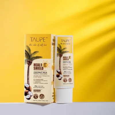 A clean product shot for Taupe's 'Heal & Shield' sunscreen against a bright yellow background. The sharp lighting, clear label, and subtle shadow play create a professional image ideal for any online storefront.