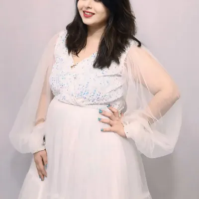 A beautiful portrait in my white sequin flare gown. It features a sparkling bodice and delicate sheer balloon sleeves for a touch of whimsical elegance.