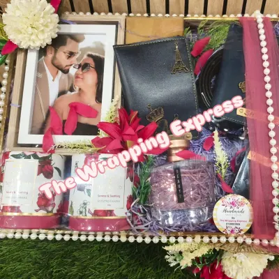This is one of my favorite hampers for a newly married couple. It's fully customized with a personal photo, matching passport covers, scented candles, and perfumes, all arranged beautifully in a decorative tray.