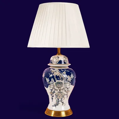 This blue and white ginger jar lamp is a classic. The intricate floral and bird design is hand-painted on the porcelain base, and the simple pleated white shade keeps the focus on the beautiful artistry of the piece.