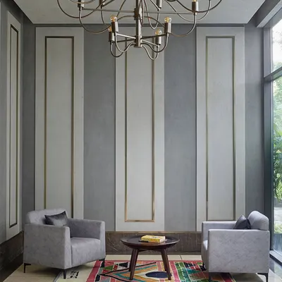 The entrance lobby for the theater and banquet at Rustomjee Elements. The design has a subtle old-world charm with contemporary touches, featuring a unique chandelier and paneled walls that set a tone of understated luxury.