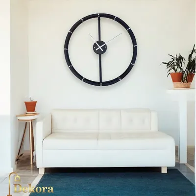 This creative wall decor clock features a large, simple black ring, embodying minimalist design for a modern living space.