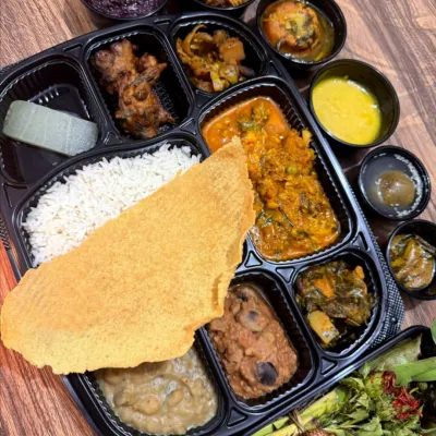 A complete Cheiraoba mathel lukoi, packed and ready for delivery. This platter includes rice, papad, Ooti, kanghou, and our special fish curry, offering a full festive experience.