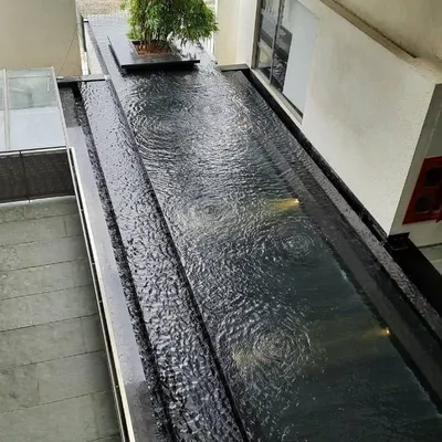 A water body at the VIT School of Architecture, which acts as a passive cooling element. The positioning of water features and wind tunnels helps to naturally regulate the building's temperature.