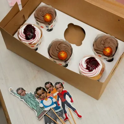 A fun set of cupcakes with custom bobblehead style toppers. The client sent me photos and I turned them into these superhero and character cutouts.
