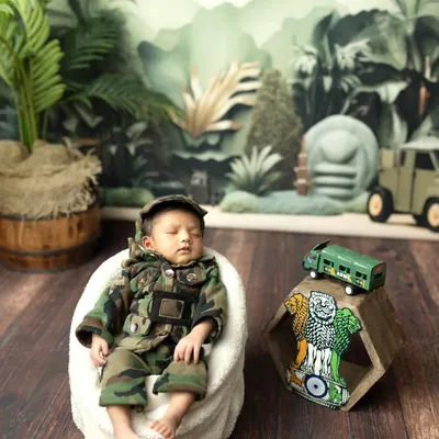 Our little patriot, dreaming big dreams. This army-themed photoshoot is a wonderful way to honor a family's service or simply create a unique and strong portrait of your newborn.