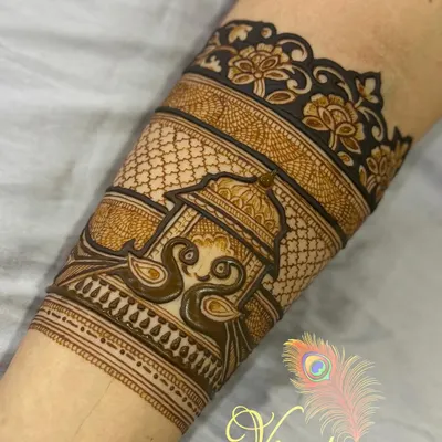 A beautiful "bridal startup" arm band featuring two swans under a canopy. The design is framed by a delicate floral border.