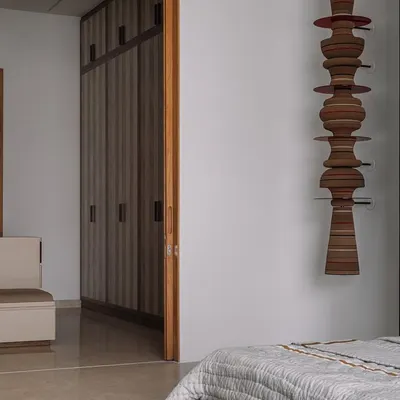 This is the parents' suite at our Rehethaan project. The family room is defined by a serene palette of ivories and ochres, with custom-designed sofas and a patterned chaise lounge creating a comfortable and elegant living space.