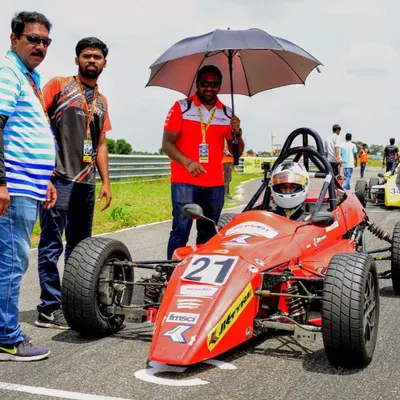 Our driver Mihir Avalakki on the starting grid in his Formula LGB car, with our team providing support right before the race begins.