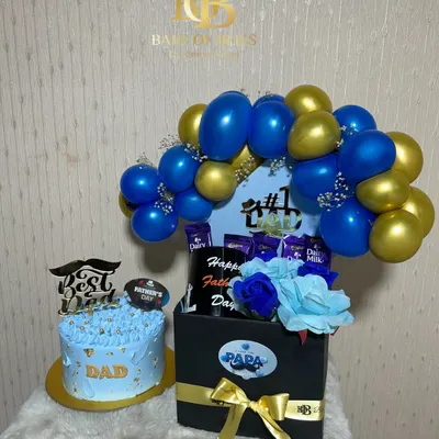 A grand gesture for the best dad. This set includes a custom-decorated cake and a large hamper box filled with chocolates, topped with a blue and gold balloon arch.