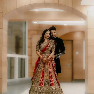 Framed by the architecture, this portrait feels like a classic painting. The couple's elegant reception attire and the intimate pose create a sense of timeless romance, a perfect memory of their wedding day.