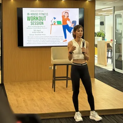 Leading a corporate wellness session. As someone who comes from a corporate background, I'm passionate about bringing fitness into the workplace. Just 30 minutes a day can transform your energy and focus.