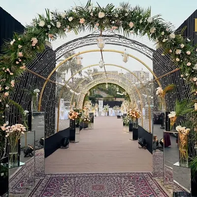 I designed this stunning entrance tunnel with cascading floral arches and a canopy of fairy lights. It creates a truly magical experience, making guests feel like they are walking through an enchanted garden on their way to the celebration.