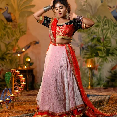 The complete Leela look in all its glory. This image showcases the combination of the black embroidered choli, the light pink skirt, and the vibrant red dupatta, perfectly capturing the film's iconic aesthetic.