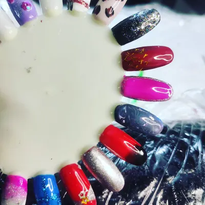 This color wheel is a great example of what students create during training. It showcases a variety of techniques on one palette, including glitter, ombre, chrome, and hand-painted art like leopard print and florals.