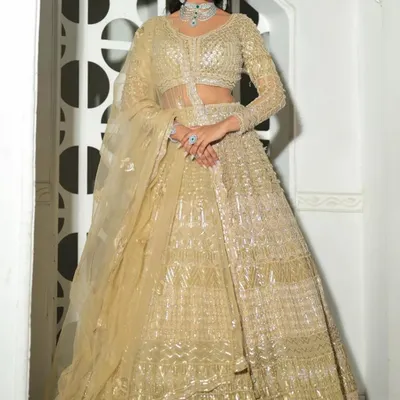 A spectacular all-gold lehenga with intricate texture and shimmer. This outfit is pure glamour and perfect for a bride's reception or sangeet.