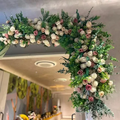 A wider view of the floral entrance decor we created. The asymmetrical design, packed with white and pink roses and rich greenery, creates a modern and dramatic welcome for any housewarming party.