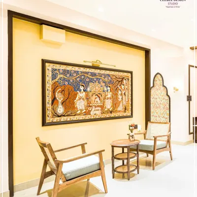 A seating nook featuring a large, framed Pattachitra painting, showcasing the celebration of India's living heritage.