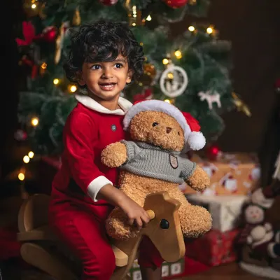 The pure joy of a child on a rocking horse, surrounded by the warm glow of Christmas. These sessions are all about capturing the wonder and excitement of the holiday season.