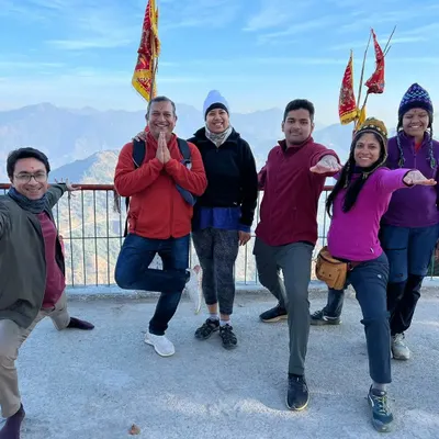 A beautiful moment from our Rishikesh retreat. We practice various asanas like Vrikshasana and Virabhadrasana together, overlooking the majestic mountains.