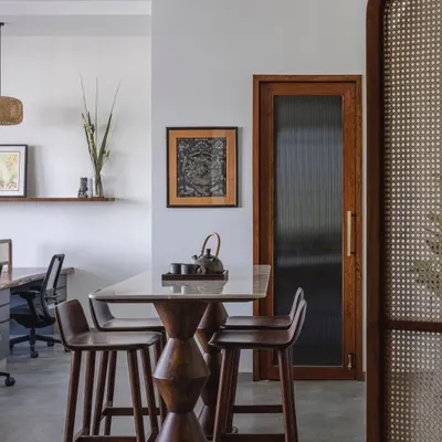 For the 'Sepalika' office in Mumbai, the brief was "a very un-office, office." We created a living room-inspired workspace with a mix of Indian and minimalist themes, using cane, wood, and glass to create a free-flowing and comfortable environment.