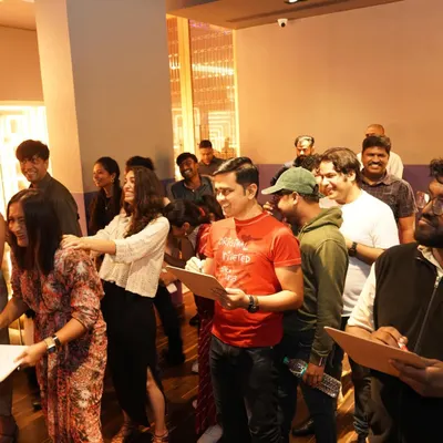 The joy and chaos of our Christmas party games! A group of attendees laughing and participating in a fun activity led by our game master.