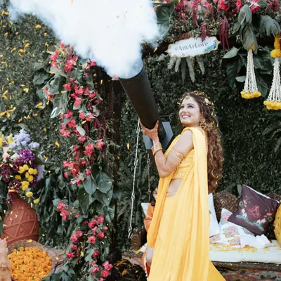 Starting the Haldi with a bang! Our bride makes a fun-filled entrance with a confetti cannon, setting a playful and celebratory tone for the day.