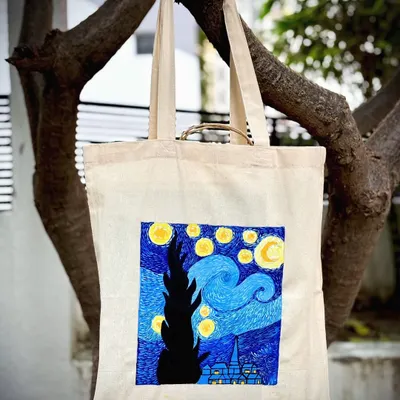 A beautiful tote bag featuring Van Gogh's "Starry Night," hand-painted by a participant in our studio. Now she can carry her masterpiece everywhere.