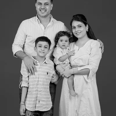 A classic black and white portrait of a beautiful family of four. These timeless photos are treasured for generations, capturing your family's unique bond.